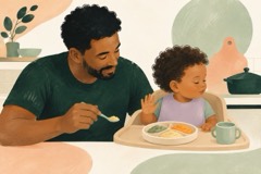 Criança vira o rosto e levanta a mão; o pai afasta a colher com calma.
